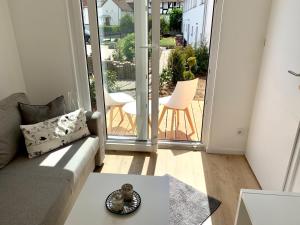 a living room with a couch and a view of a patio at Tiny Haus Liederbach in Alsfeld