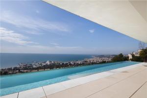 a swimming pool with a view of the ocean at Casa Nirvana - Penthouse in Sitges