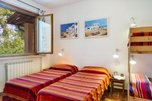 two beds sitting next to each other in a room at Trilo Dalia in Marina di Grosseto +24 photos