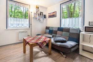 a living room with a couch and a table at Bungalow Bark Sedov, Bgl 3 in Dranske