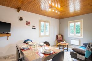 a living room with a table and a couch at Gite Prairie in Aubas