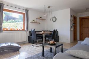 a living room with a table and chairs at Gemütliches Blockhaus im Harz in Bad Sachsa