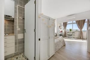 a bedroom with a bed and a bathroom with a window at Casa da Torralta in Alvor +14 photos