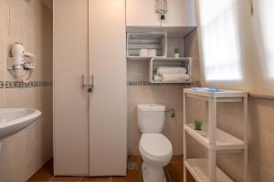 a bathroom with a white toilet and a sink at Estudio bsg Sierra Nevada in Sierra Nevada +13 photos