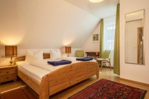 a bedroom with a large bed with two blue towels on it at Ferienwohnung Haidle in Eriskirch