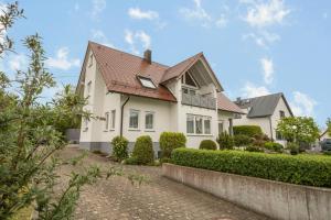 a white house with a red roof at Ferienwohnung Haidle in Eriskirch