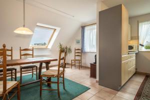 a kitchen and dining room with a table and chairs at Ferienwohnung Haidle in Eriskirch +21 photos