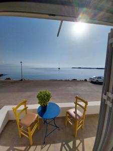 a patio with two chairs and a table and a view of the ocean at I Have A Dream in Agia Pelagia +4 photos