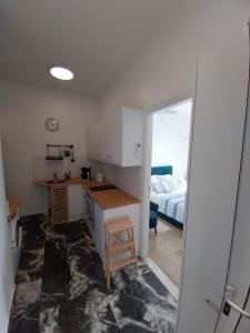 a kitchen with a desk and a bed in a room at I Have A Dream in Agia Pelagia