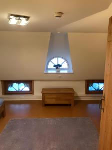 an empty room with two windows and a table at Ferienhaus Osterdeich in Neukirchen