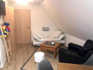 a living room with a couch and a table at Ferienhaus Osterdeich in Neukirchen