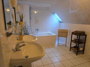 a bathroom with a sink and a bath tub at Huthaus zum Molchner Stollen in Pobershau +42 photos