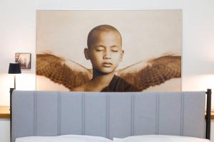 a portrait of a young boy on the side of a bed at Dimora Oberdan 1800 - Duplex 70m from Arena 6 Beds in Verona