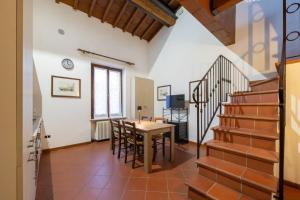 a kitchen and dining room with a table and stairs at Dimora Oberdan 1800 - Duplex 70m from Arena 6 Beds in Verona