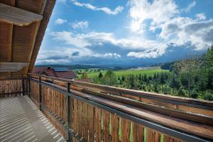 a balcony of a house with a view of the countryside at Ferienhäusl in Eschlkam