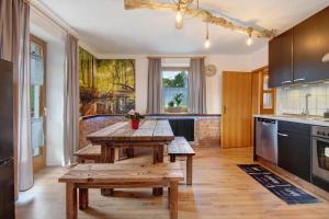 a kitchen with a wooden table in the middle at Ferienhäusl in Eschlkam