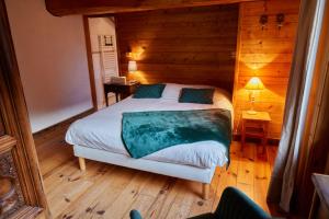 a bedroom with a bed in a wooden room at Chalet Du Houx in Les Allues +9 photos