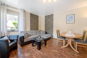 a living room with a couch and a table at Ferienwohnung Andres in Briedern