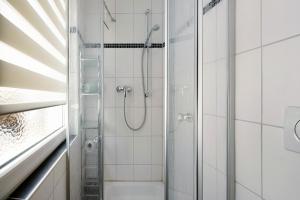 a bathroom with a shower and a toilet at Ferienwohnung Andres in Briedern +19 photos