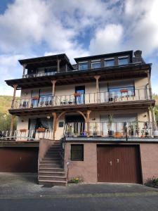 a large building with balconies and stairs on it at Haus Milaneva in Klotten