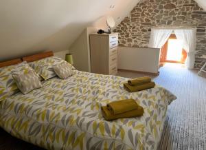 a bedroom with a bed with two pillows on it at Ensemble De Gites - Pen Ar Voas in Plestin-les-Grèves