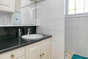 a bathroom with a sink and a mirror at Maison Ker Hélène sur grand jardin in Guérande +19 photos