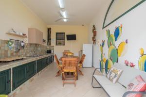a kitchen with green cabinets and a table and chairs at Ciumara West in Avola