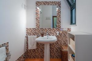 a bathroom with a sink and a mirror at Ciumara West in Avola +20 photos
