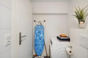 a blue skateboard hanging on a wall next to a toilet at Ferienwohnung Morgensonne in Wolfach +8 photos