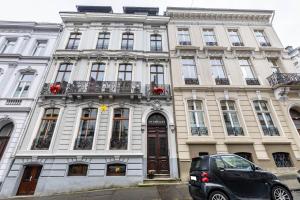 a white building with a car parked in front of it at Briller Gewölbe in Wuppertal