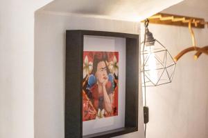 a picture in a frame on a wall with a lamp at Briller Gewölbe in Wuppertal