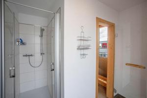 a bathroom with a shower and a glass door at Lootsen Hus by Seeblick Ferien in Olpenitz +30 photos