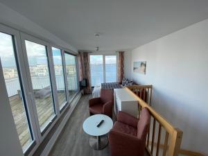a living room with a view of the ocean at Lootsen Hus by Seeblick Ferien in Olpenitz