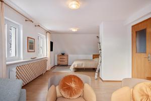 a living room with a couch and a bedroom at Haus Doktor Saeltzer in Lenzkirch