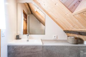 a bathroom with a sink and a wooden ceiling at Le Chalet Jarrier in Jarrier +37 photos