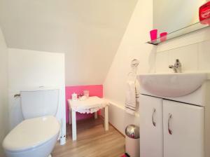 a bathroom with a white toilet and a sink at Ensemble De Gites - Pen Ar Voas in Plestin-les-Grèves +43 photos