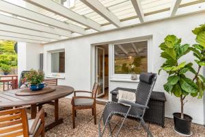 a patio with a wooden table and chairs at Haus Am Waldrand in Schenkenzell