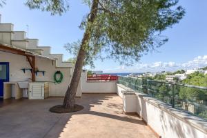 a view from the balcony of a house with a tree at E case e Leviche in Castrignano del Capo