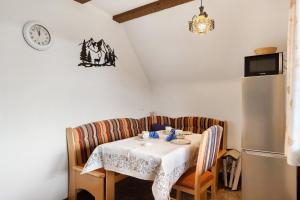 a dining room table with a white tablecloth on it at Bergbauernhof 1910 in Oberharmersbach