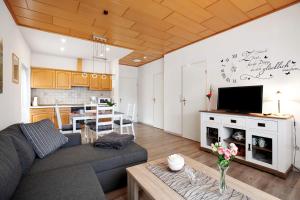 a living room with a couch and a table at Ferienwohnung 'Ferien bei Buske' in Tellingstedt