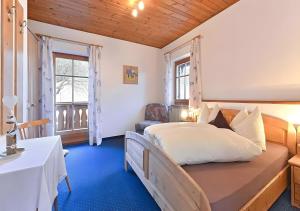 a bedroom with a large bed with a blue carpet at Appartments Radauerhof in Castelrotto