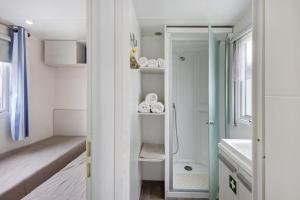a small bathroom with a shower and a sink at Villa Granja Sol 2 in São Félix da Marinha