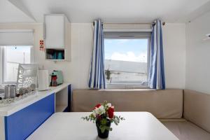 a living room with a table and a window at Villa Granja Sol 2 in São Félix da Marinha