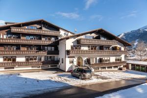 a building with a car parked in front of it at Haus Excelsior Top 2 in Seefeld in Tirol