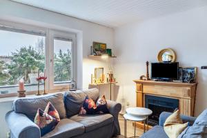 a living room with a couch and a fireplace at Haus Excelsior Top 2 in Seefeld in Tirol