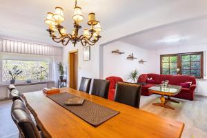 a dining room and living room with a table and chairs at Haus Waldesruh in Medebach