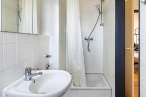 a bathroom with a sink and a bath tub at Apartment Magdeburg in Magdeburg