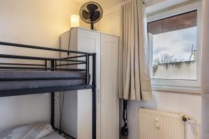 a bunk bed in a small room with a window at Apartment Magdeburg in Magdeburg