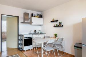 a kitchen with a table and chairs in a room at Apartment Magdeburg in Magdeburg
