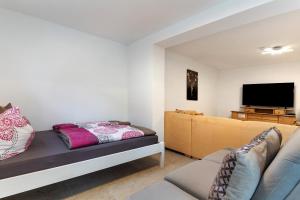 a living room with a couch and a flat screen tv at Fewo unter der Kirche in Herbolzheim